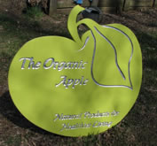 Unique custom sign in the shape of an apple. Lettering is carved and silver leafed.