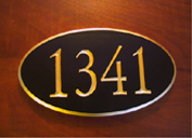 A beautiful oval carved wood sign with special request to have gold leaf on the edges