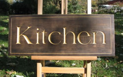 "The kitchen" sign is a very elegant addition to any kitchen or restaurant. It has a special background finish and gold leafed carved letters.