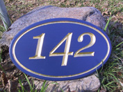 The mix of gold leaf and deep blue gives an outstanding contrast on this custom wood sign
